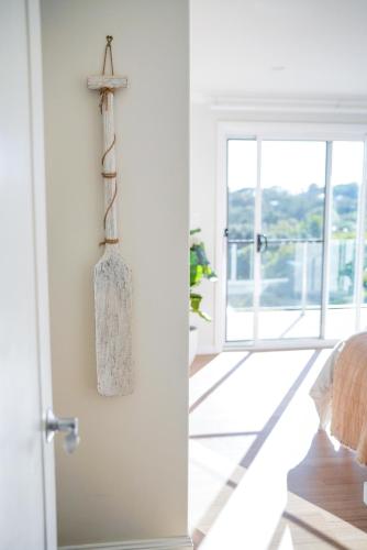 a door to a room with a cross on the wall at Diggers Beach Villa Coffs Harbour in Coffs Harbour