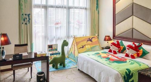 a bedroom with a bed with a toy dinosaur on it at SUN Yat-sen university Hotel and Conference Centre in Guangzhou