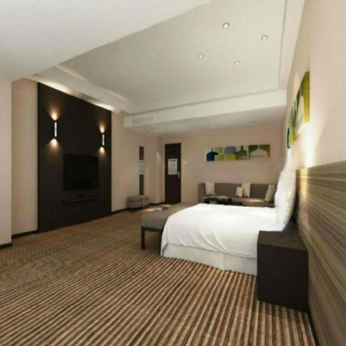 Кровать или кровати в номере Xiamenair Maple Hotel (Xiamen SM City Plaza)