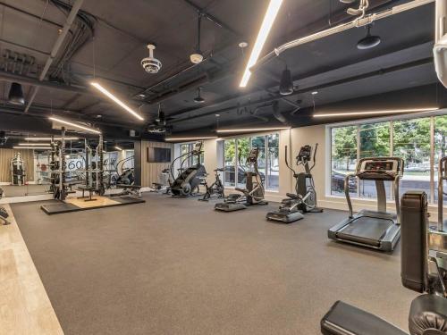 a gym with several treadmills and machines in a room at Central SLC Apartment King Bed Gym Smart TV in Salt Lake City