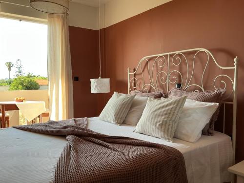 a bedroom with a large bed with white pillows at Kamara Apartments Marmari in Marmari