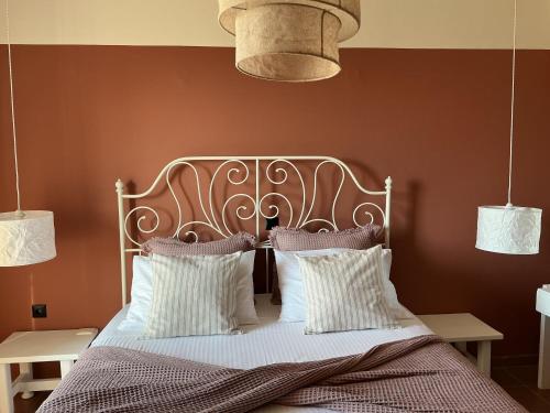 a bed with a metal headboard and two pillows at Kamara Apartments Marmari in Marmari