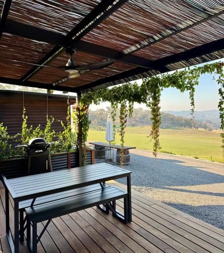a wooden deck with a picnic table on it at Bluestone Ridge in Whitfield