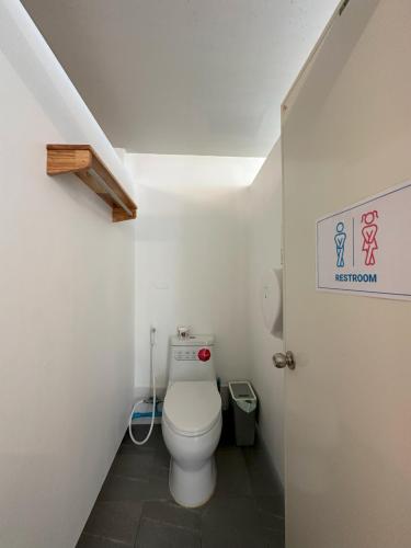 a bathroom with a white toilet in a room at Blue Horizon Hostel By Blue Flow in Phi Phi Don