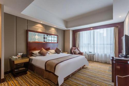 a hotel room with a large bed and a large window at Hohhot Hai Liang Plaza Hotel in Hohhot