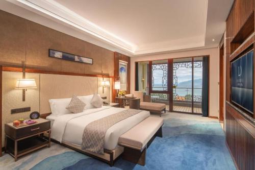 a hotel room with a bed and a television at Dali Hotel in Dali