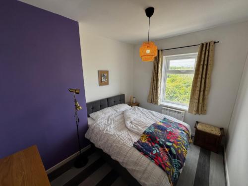 a bedroom with a bed and a window at Tidal House in Cambois
