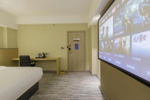 a hospital room with a large projection screen at Jingtu hotel zhanjiang dingsheng plaza store in Zhanjiang