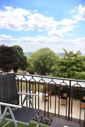 a chair sitting on top of a balcony at Best Western Hotel Ile de France in Château-Thierry
