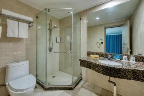 a bathroom with a shower and a toilet and a sink at GreenTree Inn Hotel - Nantong Hongming Plaza in Nantong