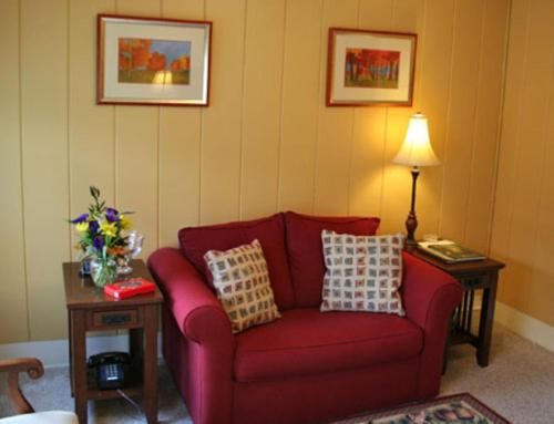a living room with a red couch and a table at Wildcat Inn and Tavern in Jackson