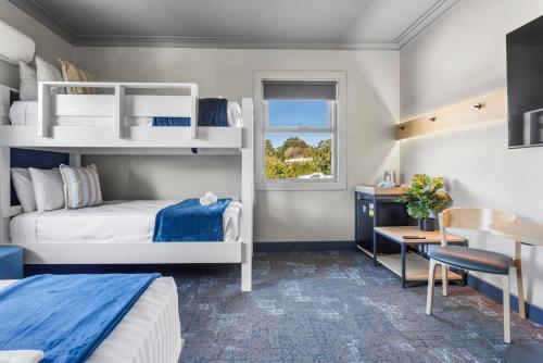 a bedroom with two bunk beds and a desk at Hotel Jesmond in Newcastle
