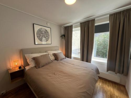 a bedroom with a bed and a window at Cozy Gem in the Heart Of Bergen in Bergen
