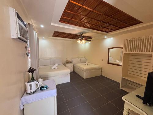a living room with two beds and a couch at Seabird International Resort in Boracay