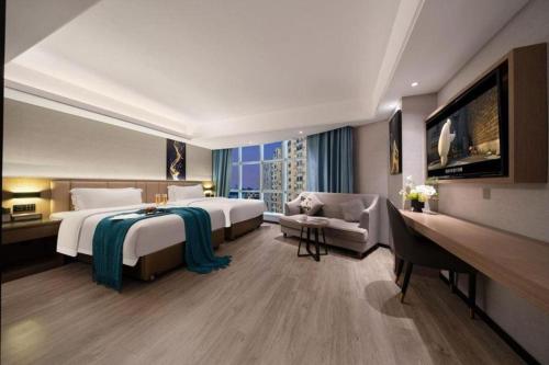 a large hotel room with two beds and a couch at Nanning Prince Hotel in Nanning