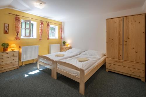 a bedroom with a large bed and wooden cabinets at Bouda Pavlovka in Dolní Malá Úpa