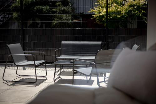a table and chairs and a bench on a patio at KopfRausch Appartements in Feldkirch
