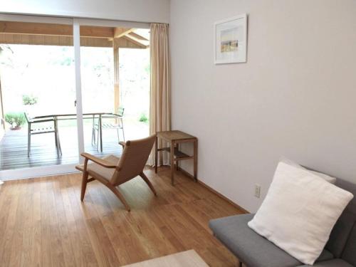 a living room with a couch and a table at HOTEL HOLIDAY HOME in Kyotango
