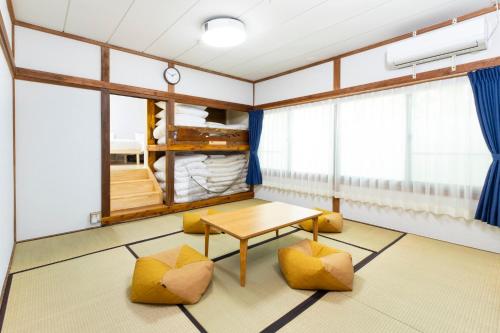 a room with a table and two yellow chairs at VillaLakeIrodori in Fujikawaguchiko