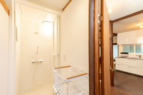 a bathroom with a walk in shower and a shopping cart at VillaLakeIrodori in Fujikawaguchiko