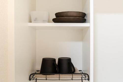 a shelf with two bowls and plates on it at Parkside Shinjuku Tokyo in Tokyo