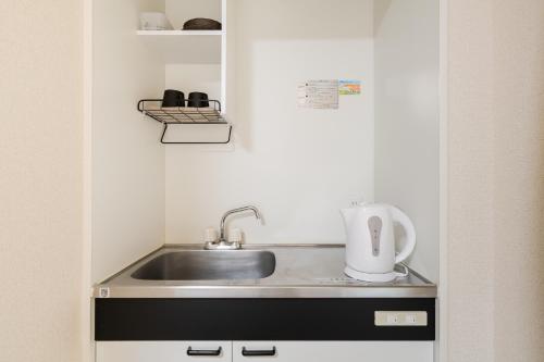 a kitchen counter with a sink and a mixer at Parkside Shinjuku Tokyo in Tokyo