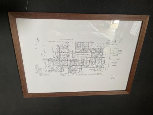 a drawing of a building in a wooden frame at 古民家ラグジュアリーホテル 金井西洋館 in Sado