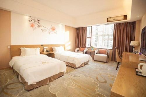 Ένα ή περισσότερα κρεβάτια σε δωμάτιο στο BI YING HOTEL