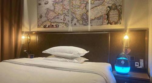 a bedroom with a bed with a map on the wall at James Joyce Coffetel Xi'an Lingtong The Terracotta Army Huaqingchi University Town Metro Station in Xi'an