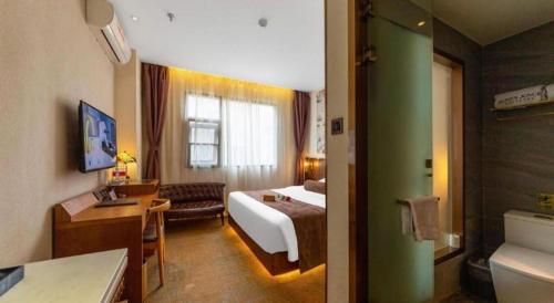a hotel room with a bed and a bathroom at James Joyce Coffetel Xi'an Lingtong The Terracotta Army Huaqingchi University Town Metro Station in Xi'an