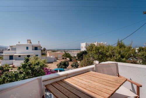 a balcony with a wooden table and two chairs at Maroulis Studios Naxos in Mikri Vigla