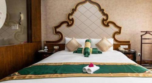 a bedroom with a large bed with a large headboard at Hohhot Inner Mongolia Hotel in Hohhot