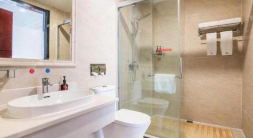 a bathroom with a sink and a toilet and a shower at GreenTree Inn Kunming Baiyun Road Tongde Plaza Branch in Kunming