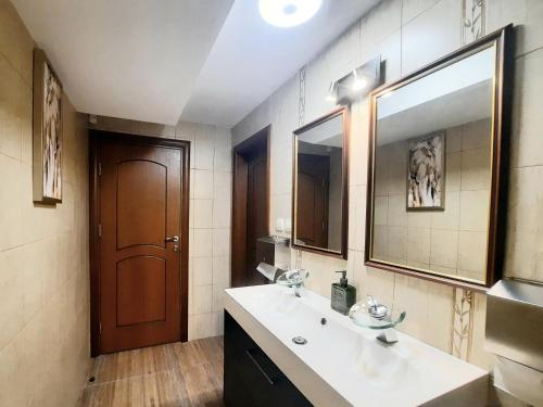 a bathroom with a sink and a mirror at Family hotel Delfa in Chernomorets