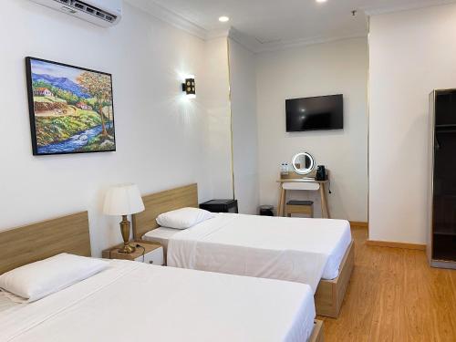 Una cama o camas en una habitación de Huong Sen 2 Vung Tau Hotel