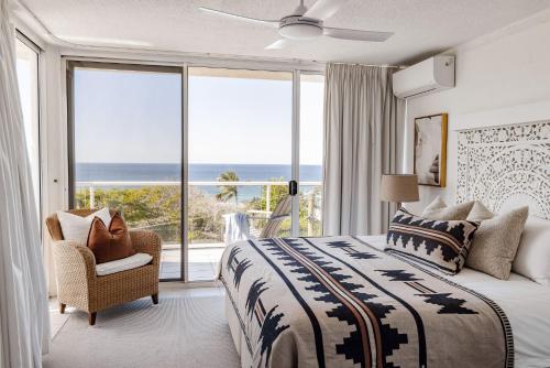 a bedroom with a bed and a view of the ocean at Hydra - 3 Bedrooms, Ocean views, Pool in Sunshine Beach