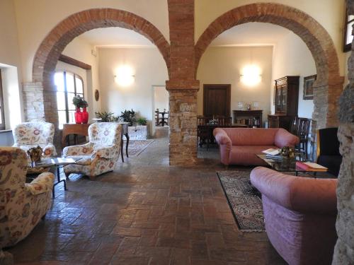 a living room filled with furniture and a fire place at Relais Borgo Di Toiano in Sovicille