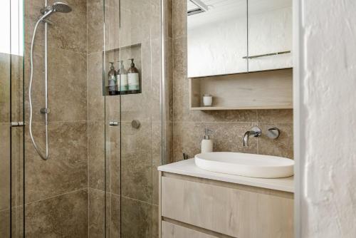 a bathroom with a sink and a shower at Hydra - 3 Bedrooms, Ocean views, Pool in Sunshine Beach