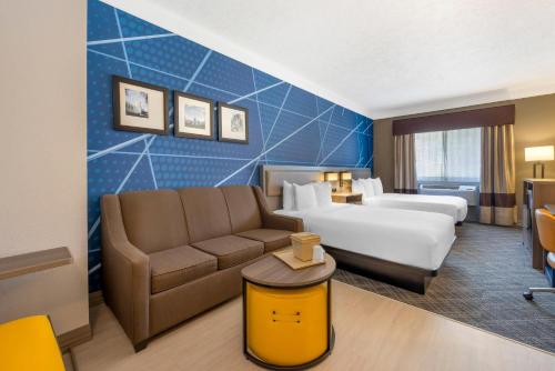 a hotel room with a bed and a couch at Comfort Suites Salem in Salem