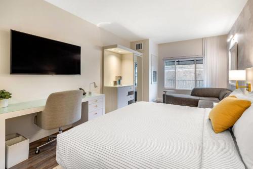 a bedroom with a bed and a desk with a tv at Cambria Hotel Calabasas - Malibu in Calabasas