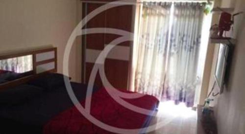 a bedroom with a bed and a window at Bogor Valley Hotel in Bogor