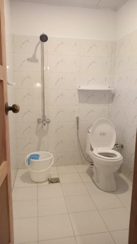 a white bathroom with a toilet and a bidet at Bucolic River Resort in Gulmit