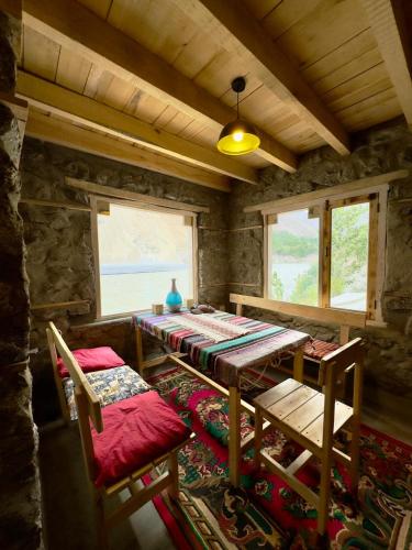 a dining room with a table and two chairs at Bucolic River Resort in Gulmit