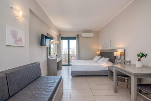 a hotel room with a bed and a desk at Christina Beach Hotel in Kissamos