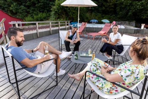 a group of people sitting in chairs on a deck at DAS SCHÖNE LEBEN Pop-Up Hotel in Hornberg