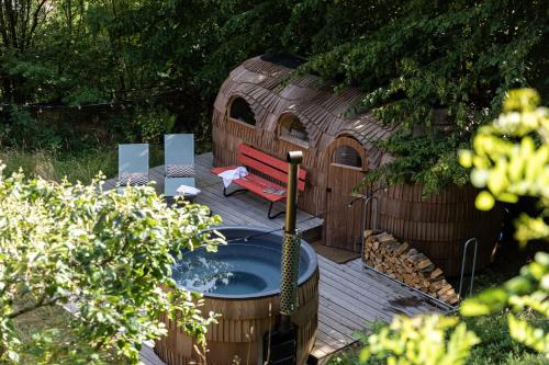 a wooden deck with a bench and a play house at DAS SCHÖNE LEBEN Pop-Up Hotel in Hornberg