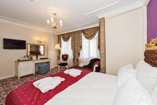 a hotel room with a bed with two towels on it at Galatower Hotel in Istanbul