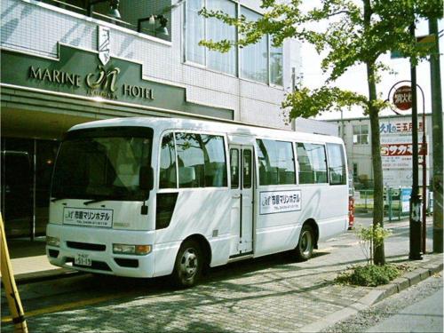 a white bus parked in front of a building at Ichihara Marine Hotel - Vacation STAY 01372v in Ichihara