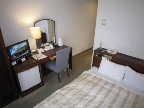 a hotel room with a bed and a desk with a computer at Ichihara Marine Hotel - Vacation STAY 01365v in Ichihara