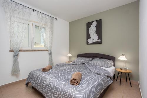 a dog laying on a bed in a bedroom at Villa Sbay in Omišalj